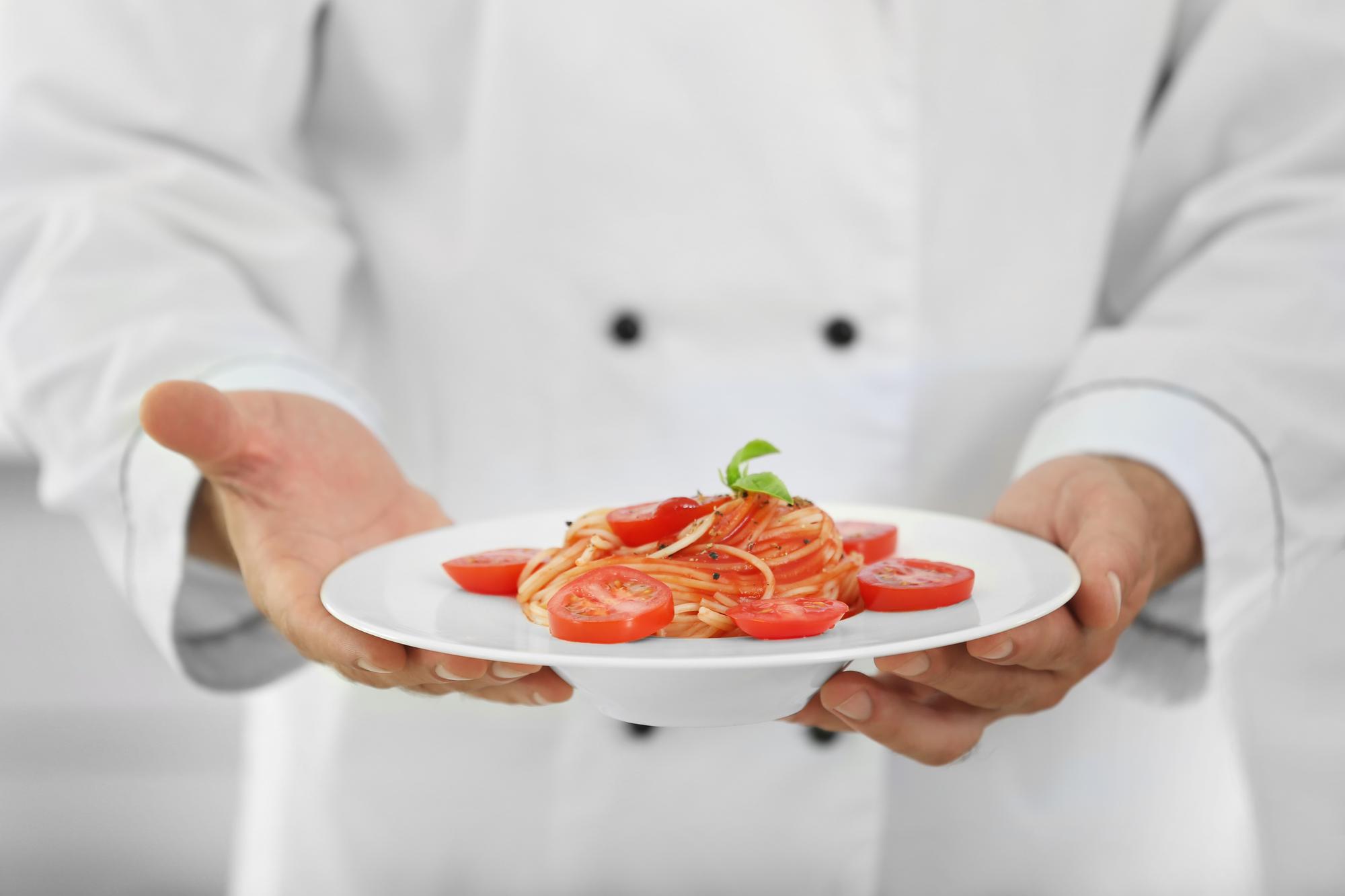 Chef hands plating in compact studio